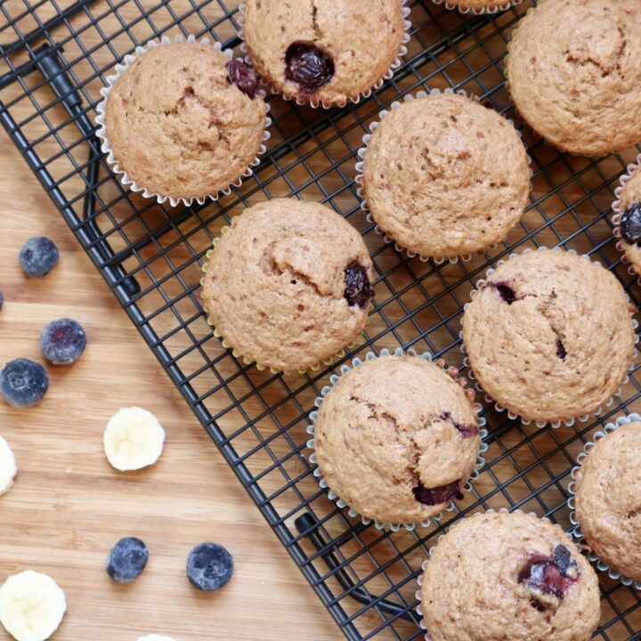 Blueberry banana muffins on a cooling rack angled to the left