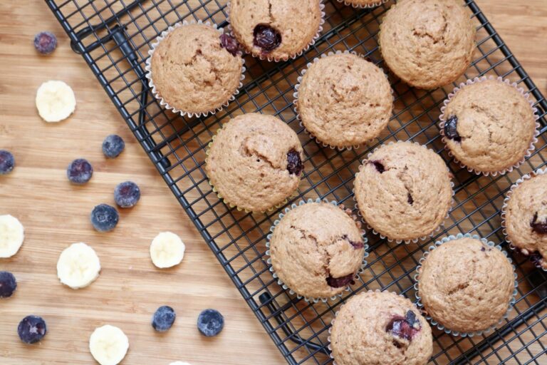 Blueberry banana muffins on a cooling rack angled to the left