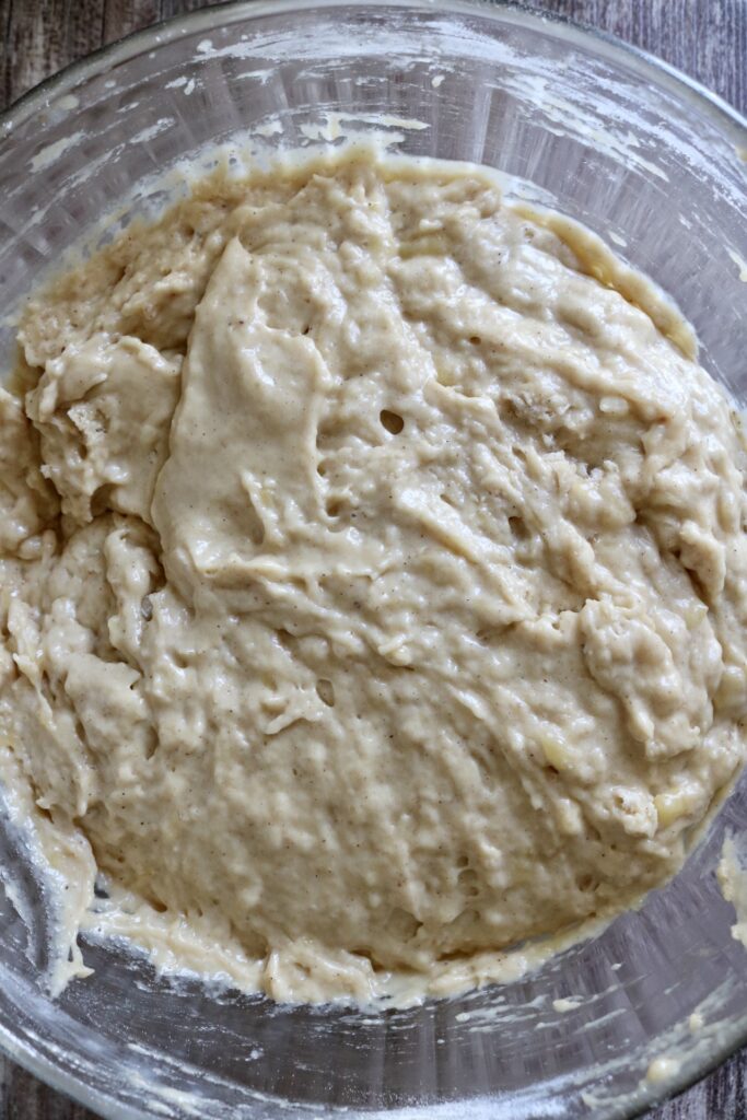 sourdough banana bread batter in a glass bowl