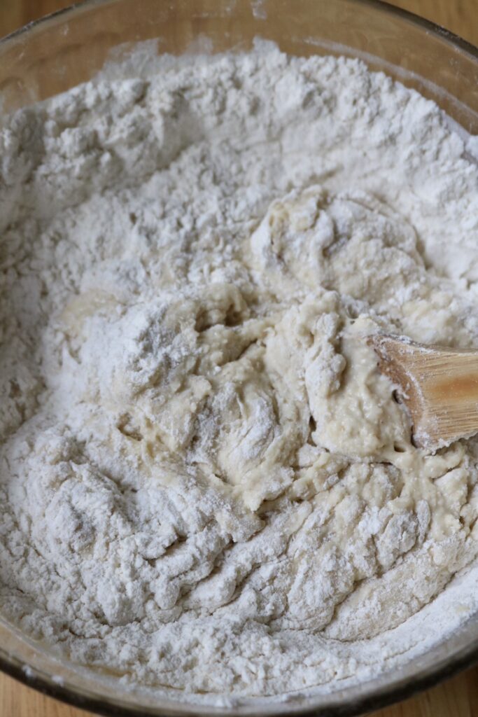mixing dough with a wooden spoon