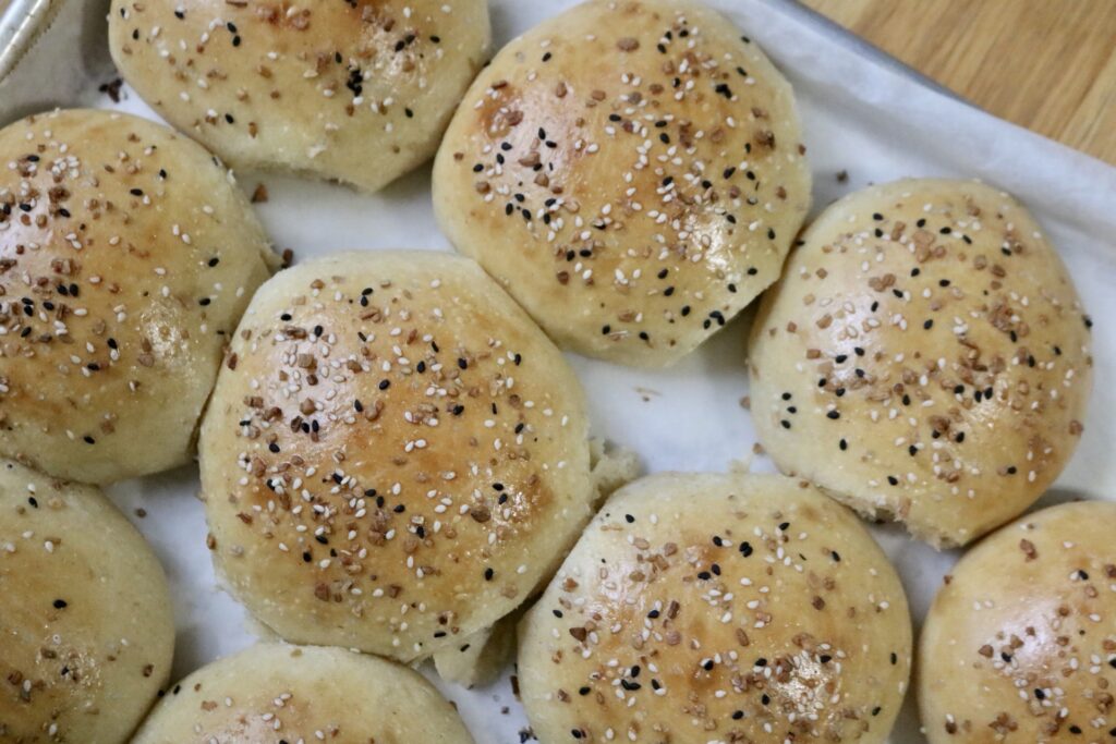 top view of sourdough burger buns on a baking sheet