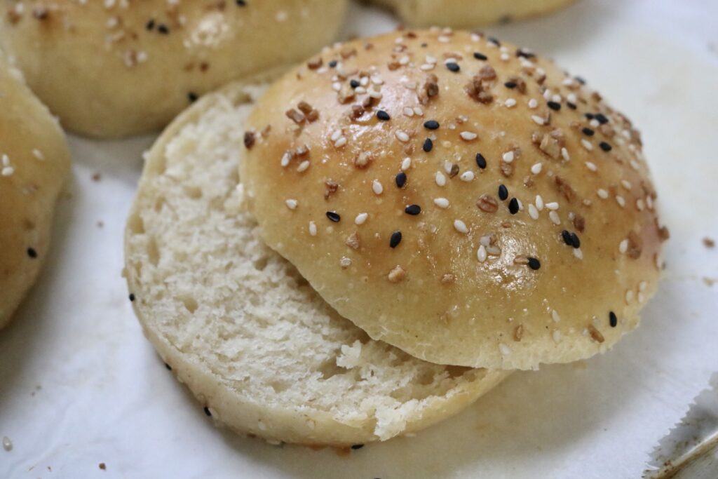 bun sliced in half with the top of the bun set slightly off the bottom