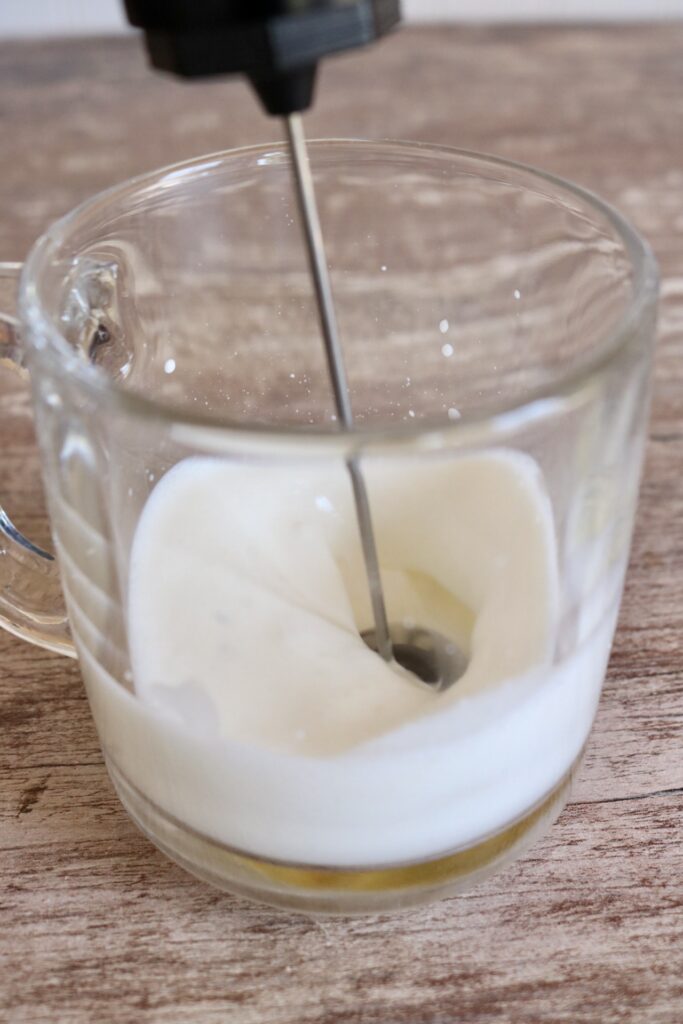 frothing milk and cream with a handheld milk frother
