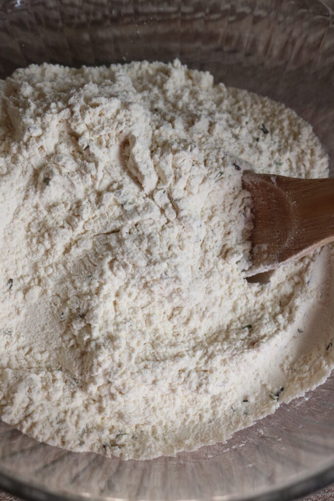 flour in a bowl with a wooden spoon