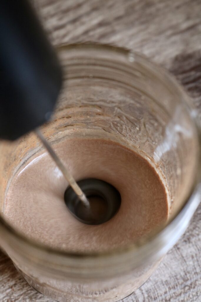 frothing chocolate cold foam using a handheld milk frother