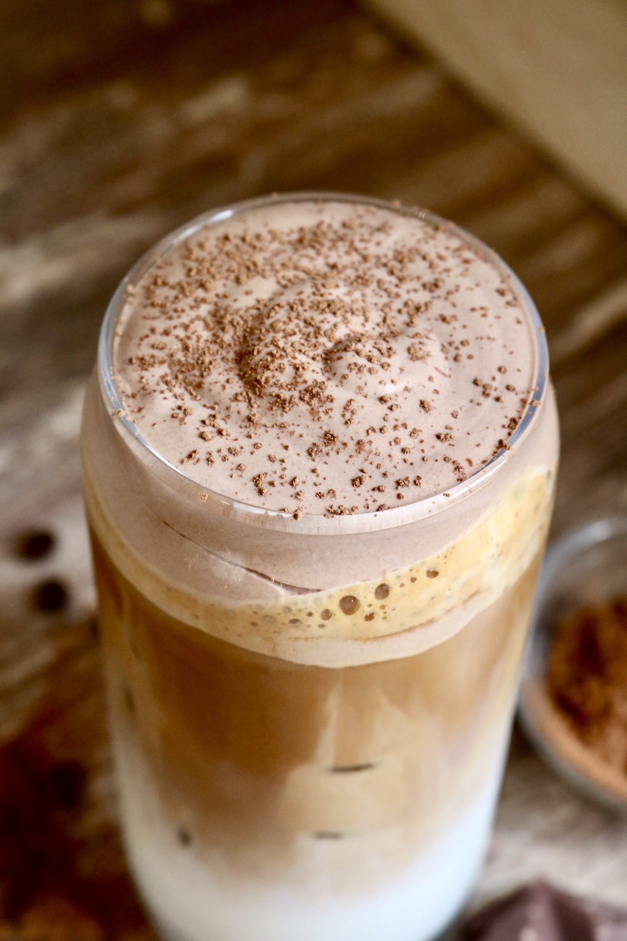 chocolate iced latte with cocoa powder sprinkled on top