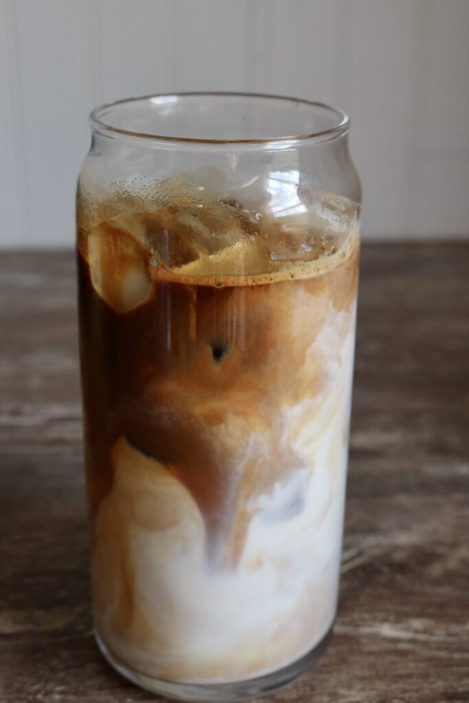 tall glass with ice milk and espresso