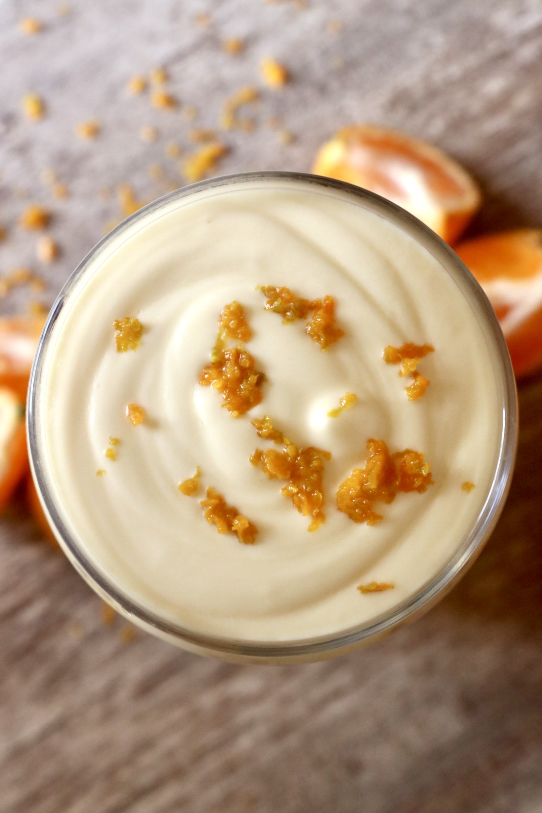 top shot of orange cream cold foam latte with orange zest sprinkled on top