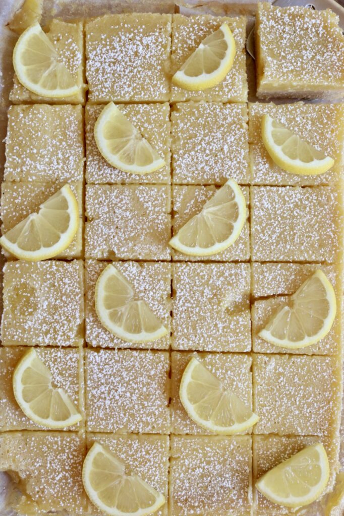 sliced lemon bars with lemon slices on top