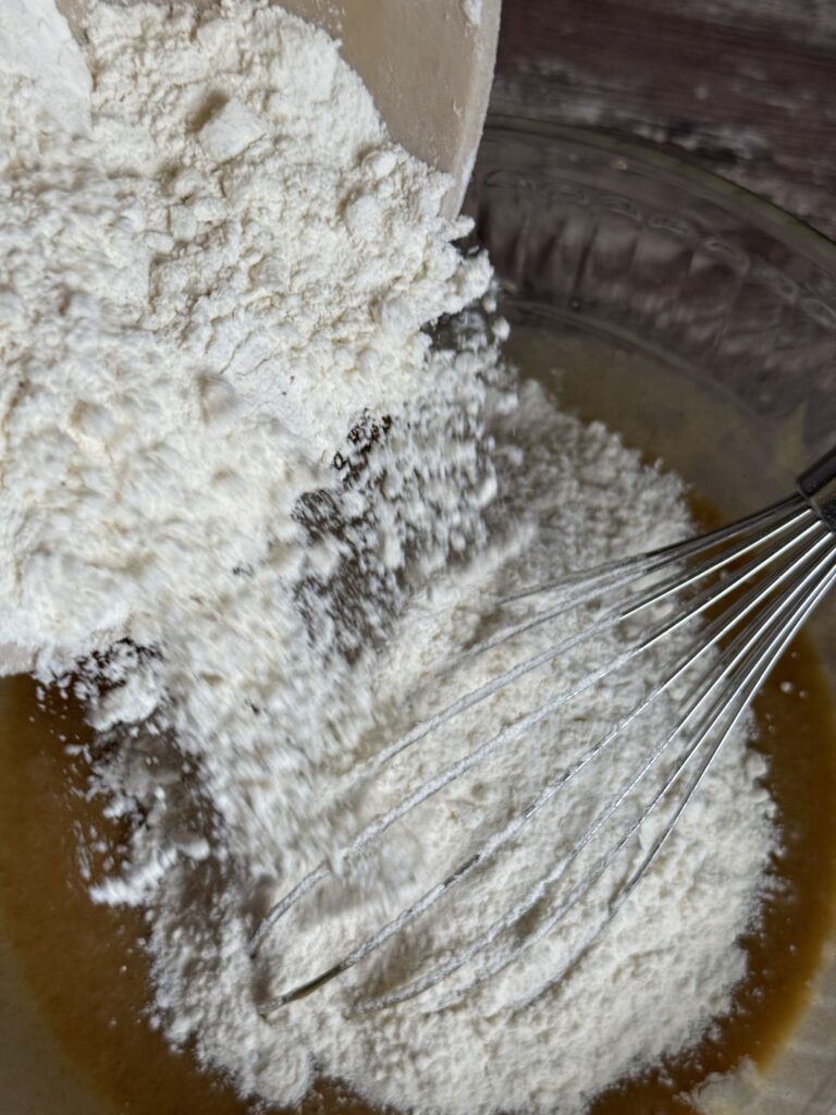 pouring flour into wet ingredients