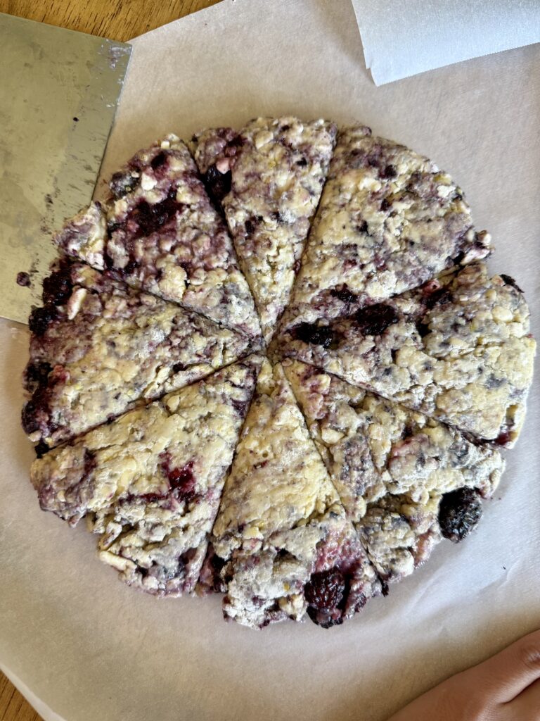 disc of sourdough blackberry lemon sourdough scone sliced into 8 triangular sections