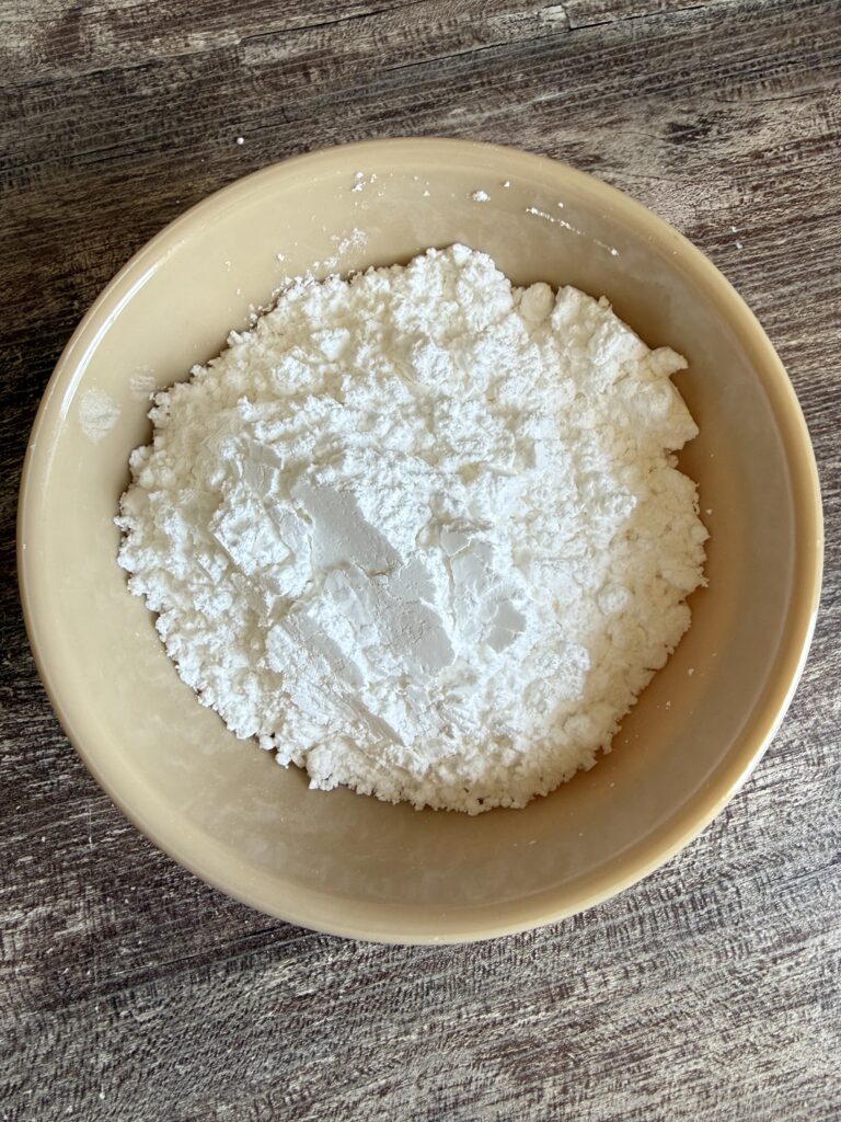 powdered sugar in a tan bowl