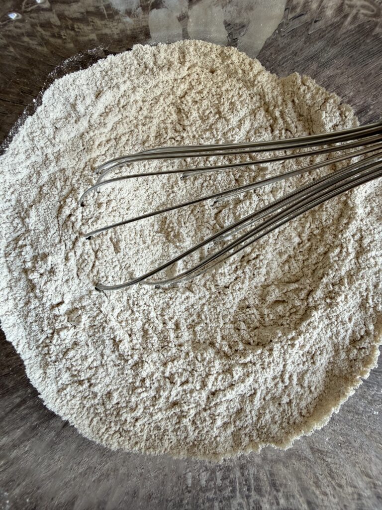 whisking flour in a bowl