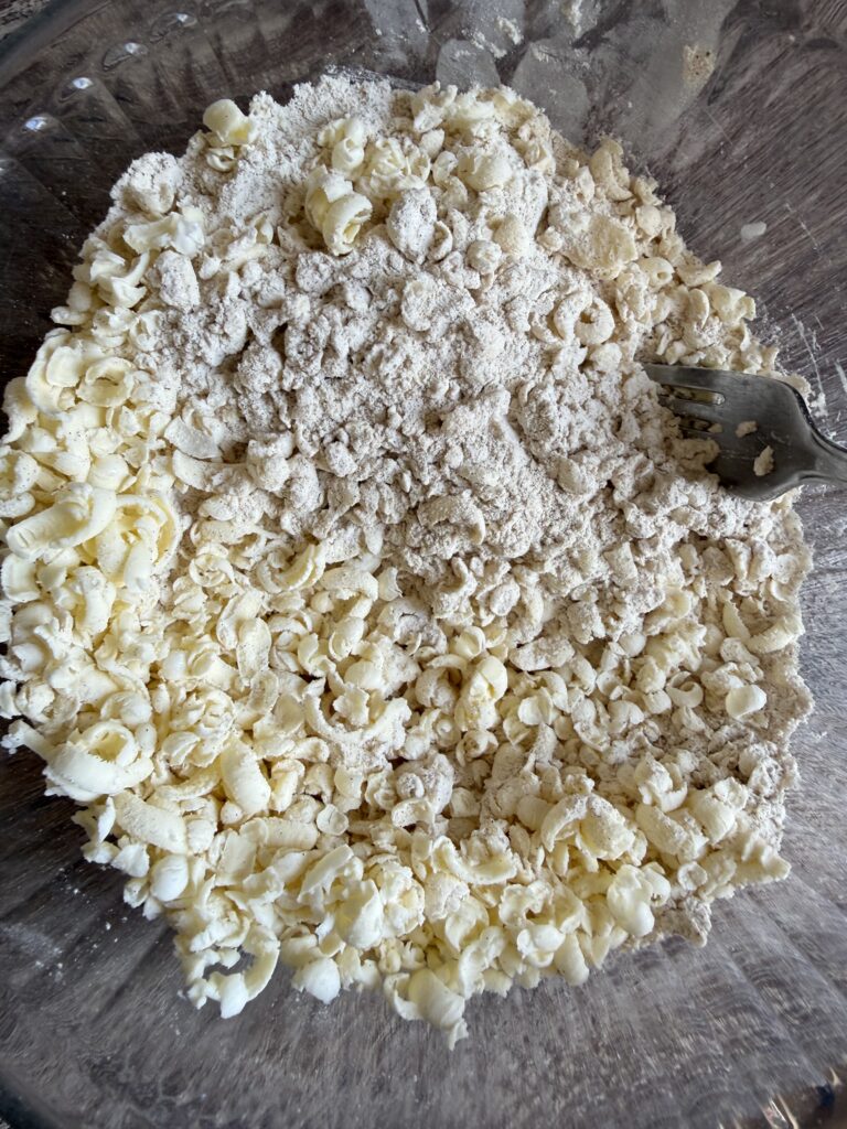 grated butter in a bowl of flour