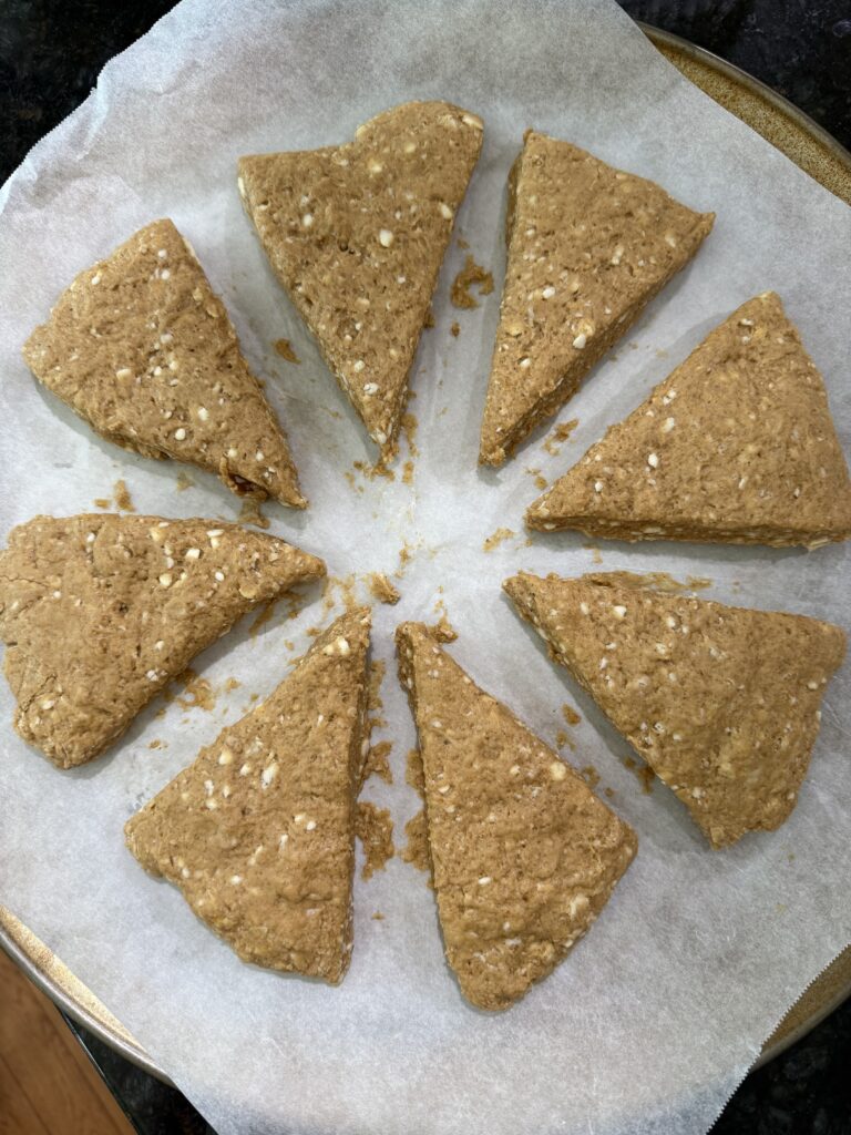 8 triangles of scone dough on a parchment paper lined pan
