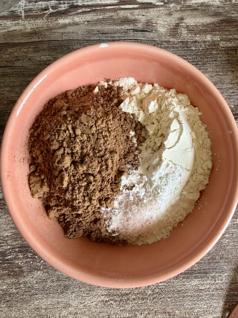 flour and cocoa powder in a pink bowl