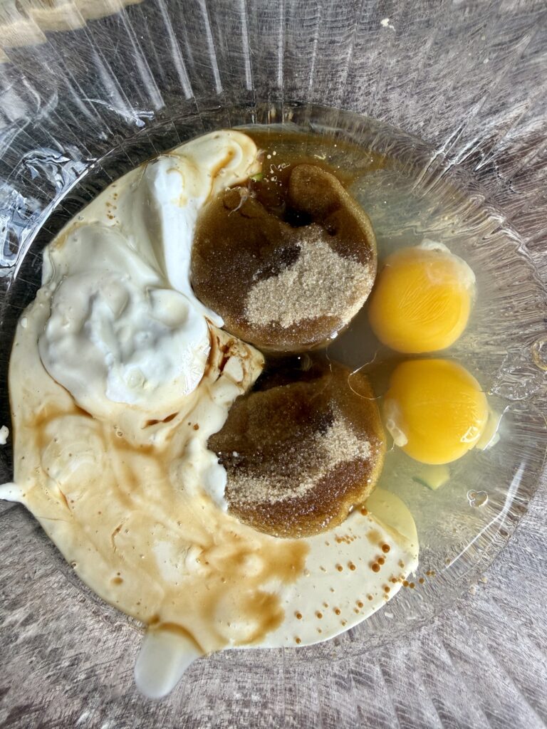 brown sugar eggs sourdough starter yogurt and vanilla in a glass bowl