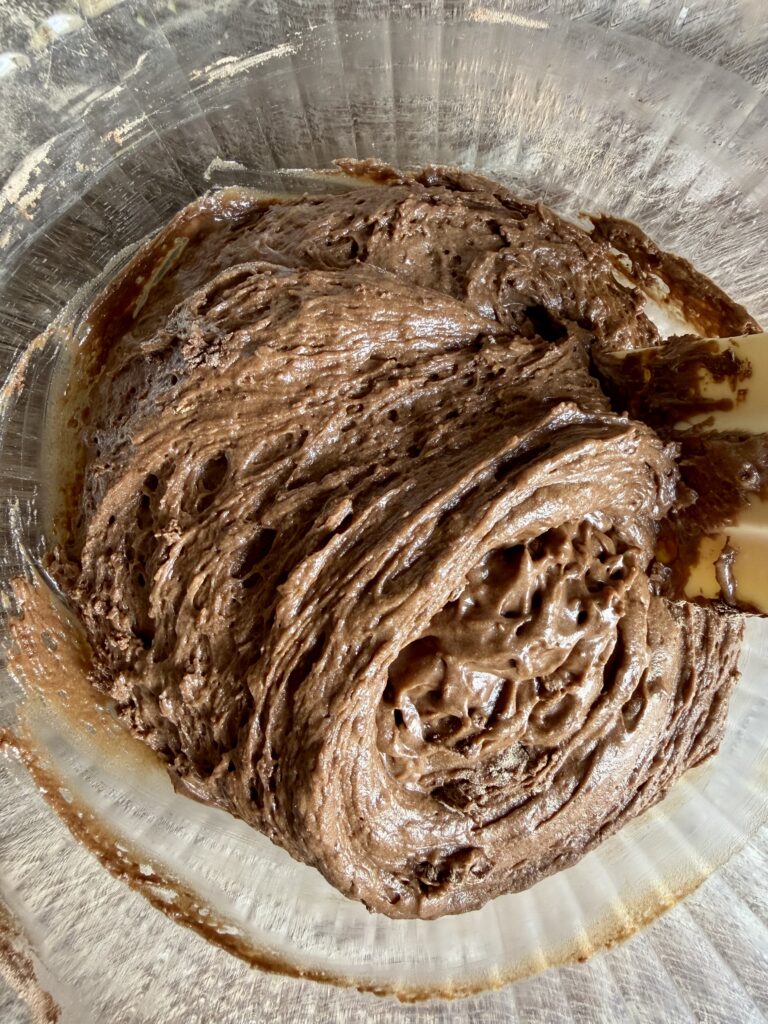 stirring chocolate bread dough with a spatula