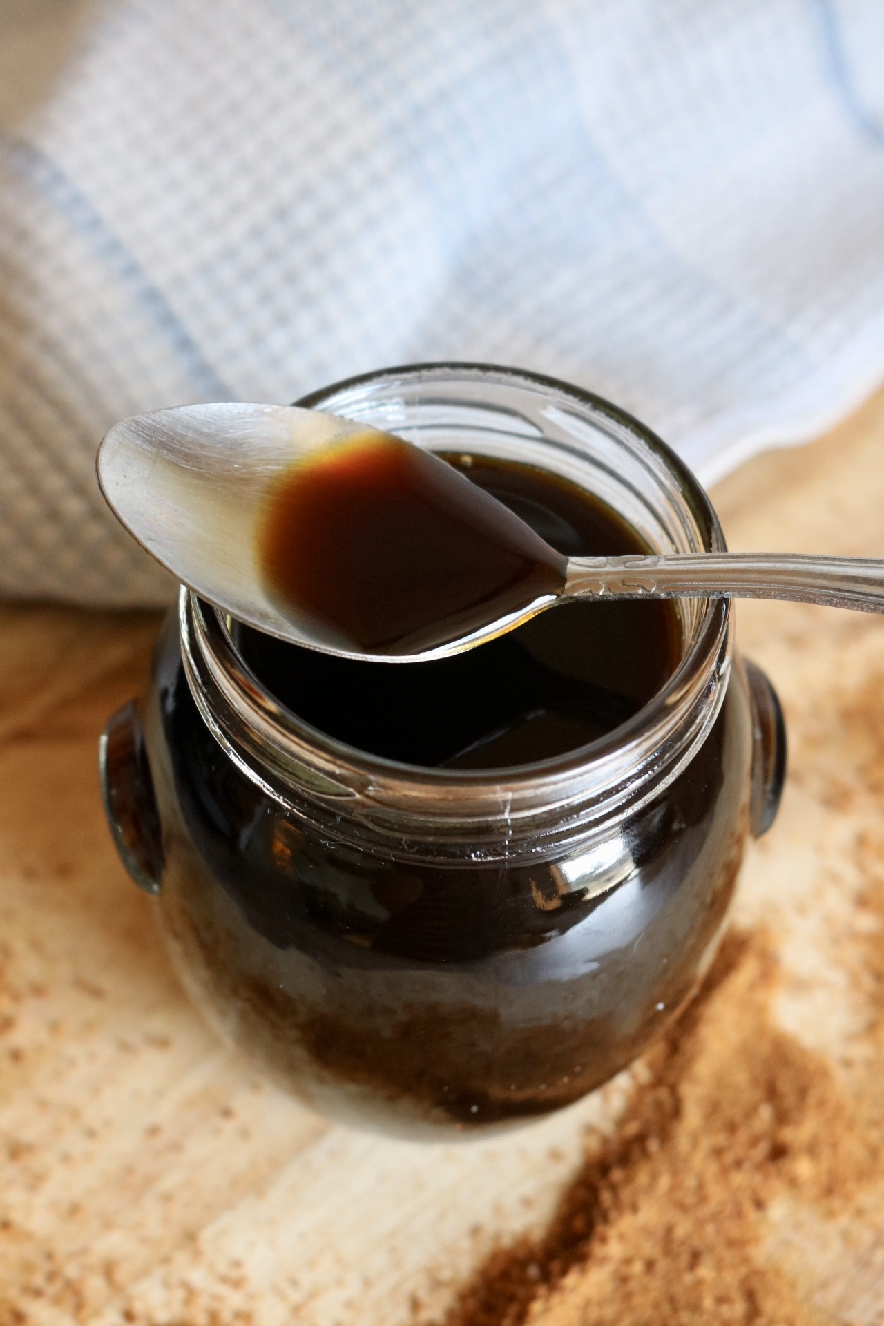 jar of salted caramel coffee syrup with a spoon resting on it