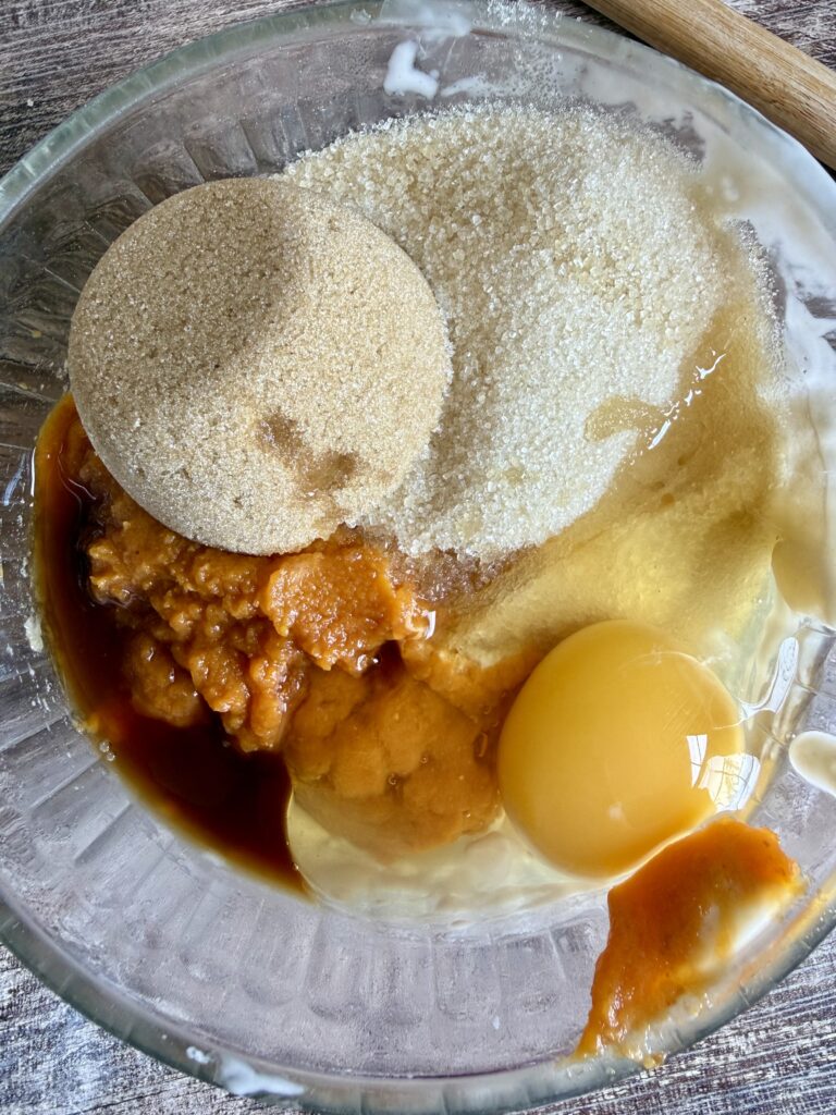 brown sugar, white sugar, egg, pumpkin puree, and vanilla extract in a glass bowl